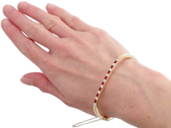 wearing ruby and diamond yellow gold bangle