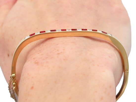ruby and diamond yellow gold bangle being worn