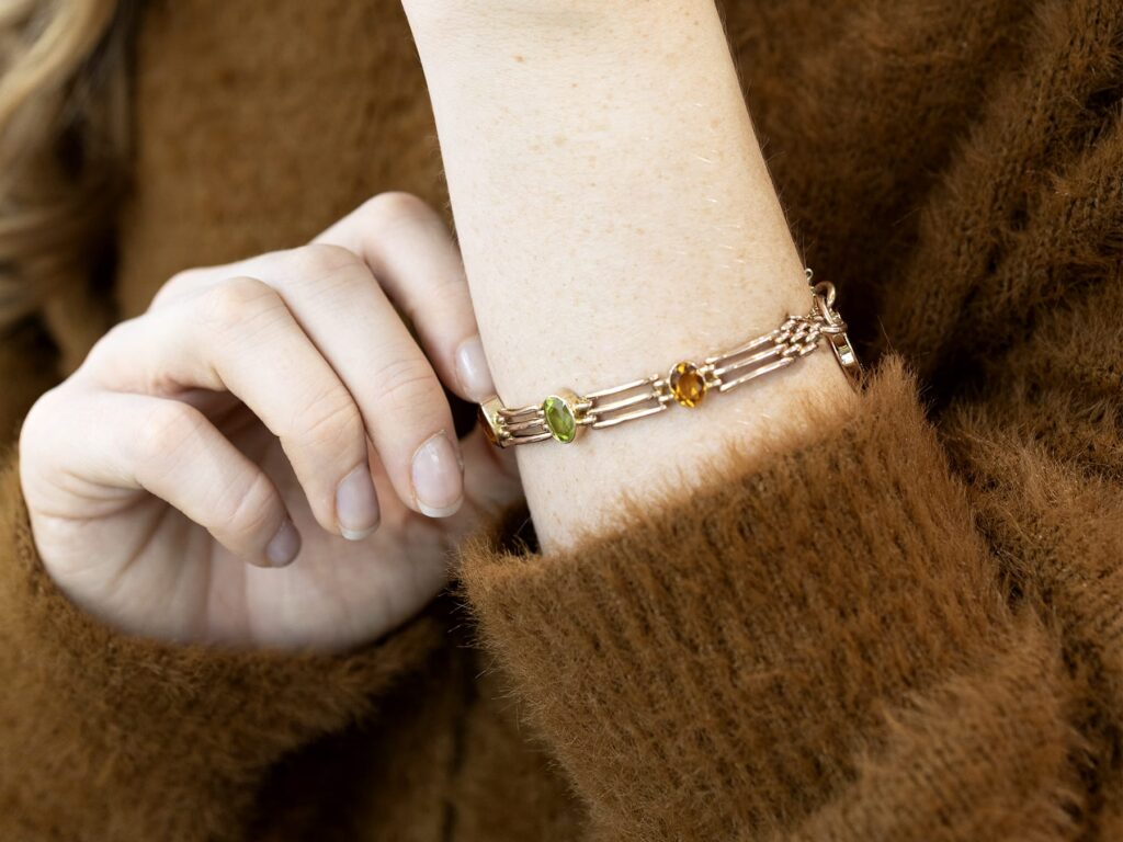 citrine and peridot gold gate bracelet on wrist 