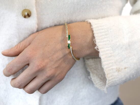 Emerald and Diamond Bangle in Yellow Gold wearing