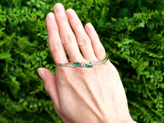 Emerald and Diamond Bangle in Yellow Gold outside