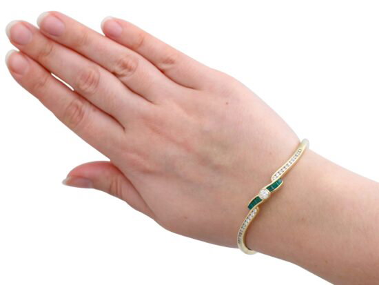 wearing Emerald and Diamond Bangle in Yellow Gold