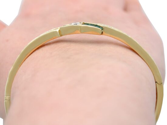 Emerald and Diamond Bangle in Yellow Gold on wrist
