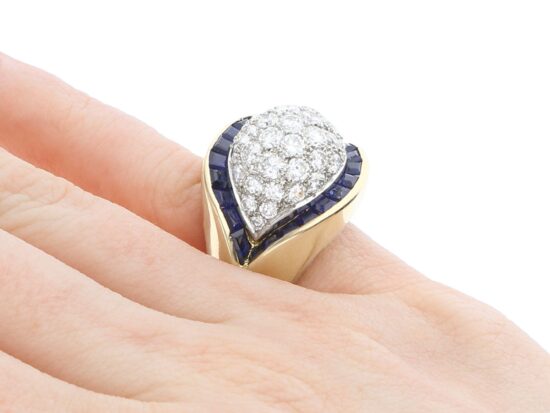 unusual gold sapphire and diamond ring on finger