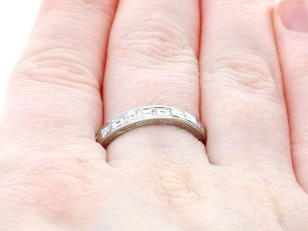 princess and baguette cut eternity ring on finger