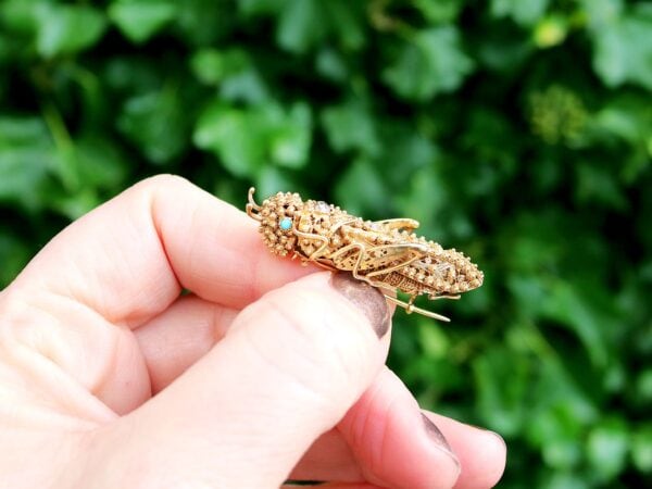 antique gold grasshopper brooch outside