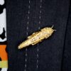 wearing an antique gold grasshopper brooch