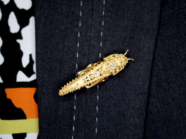 wearing an antique gold grasshopper brooch