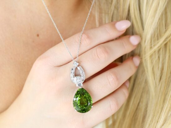 Pear shaped peridot pendant in platinum with diamonds