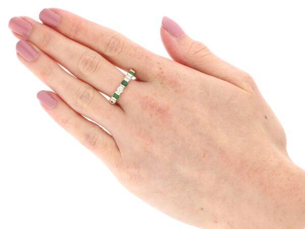 emerald and diamond eternity ring on hand