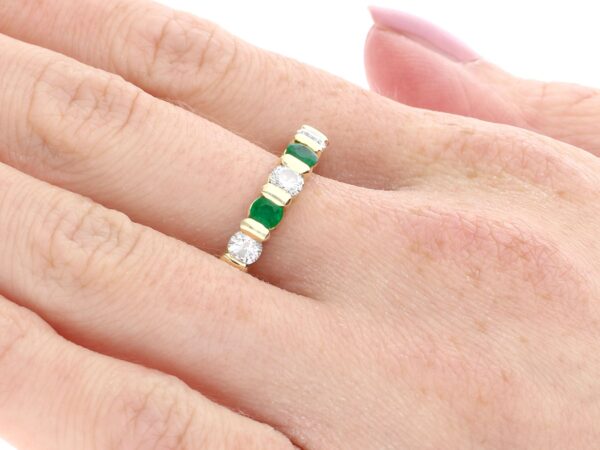 emerald and diamond eternity ring on finger