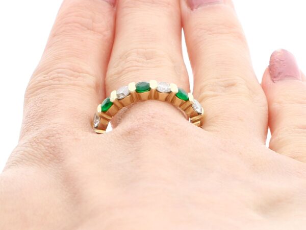 wearing a emerald and diamond eternity ring