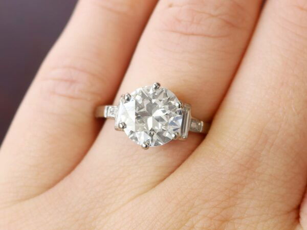 wearing a 1930s diamond solitaire ring in 18k white gold