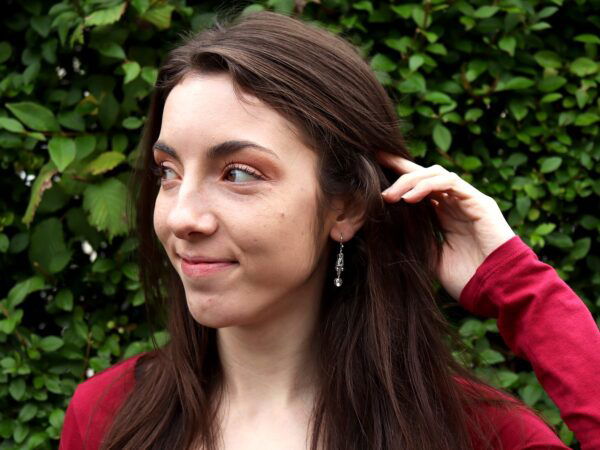 wearing platinum Art Deco diamond drop earrings