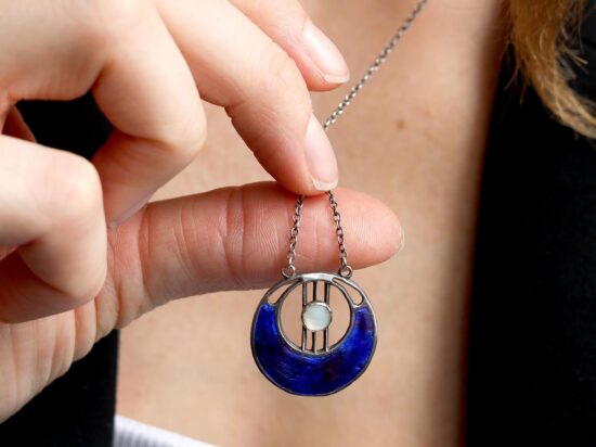 wearing enamel and pearl pendant