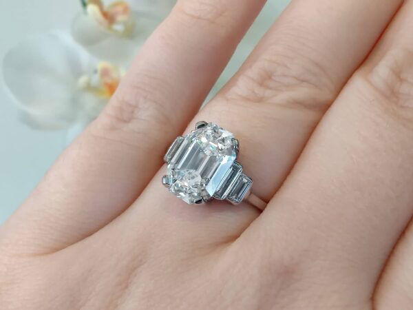 wearing emerald cut diamond ring in platinum