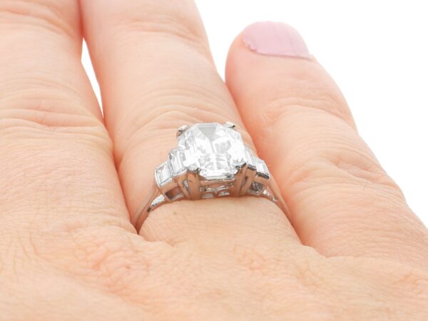 emerald cut diamond ring on finger