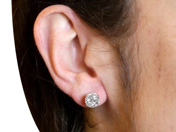 wearing Edwardian diamond stud earrings