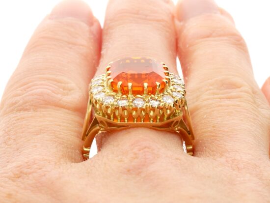 Close Up Fire Opal Dress Ring on Finger