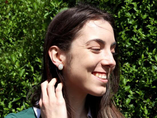 Gold Opal Earrings Being Worn
