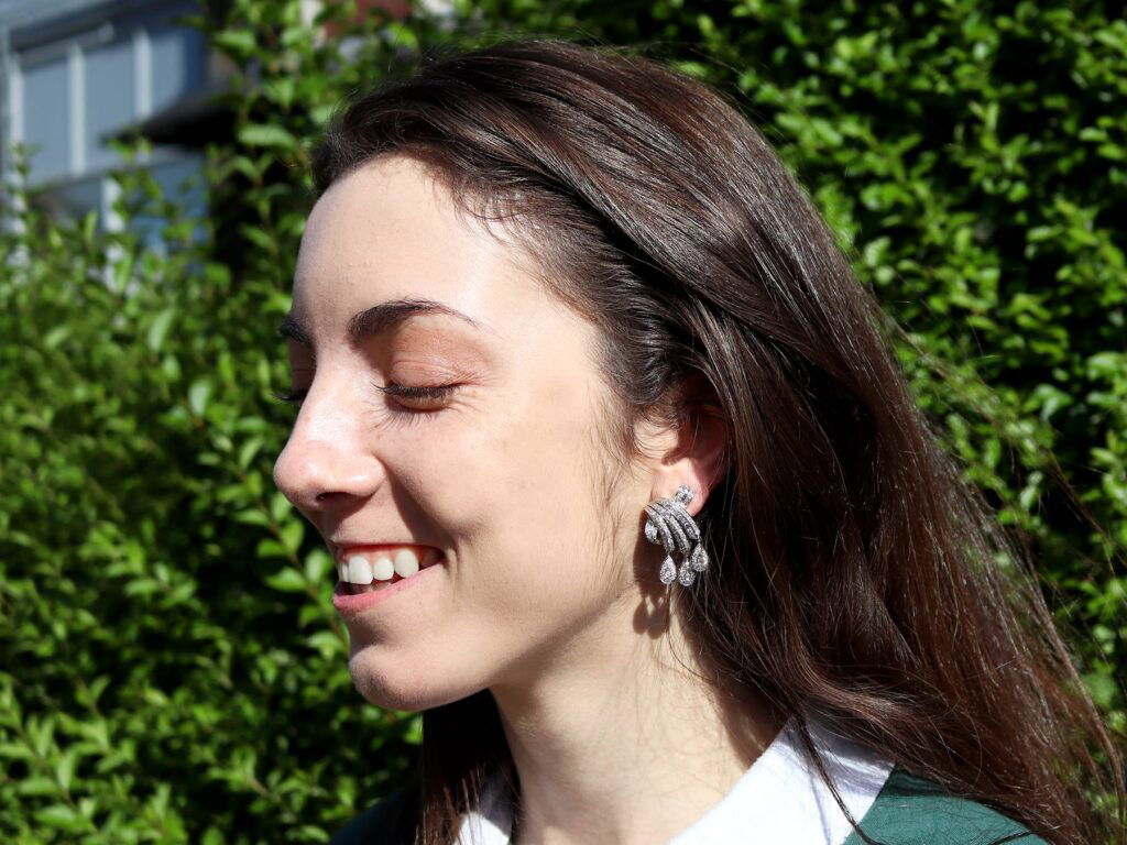 wearing platinum diamond drop earrings