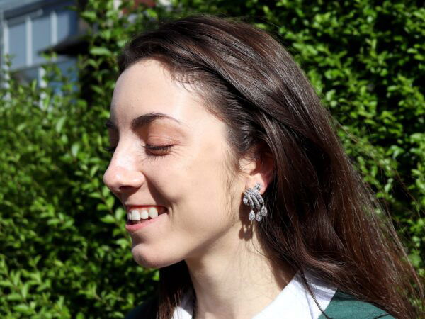 wearing platinum diamond drop earrings
