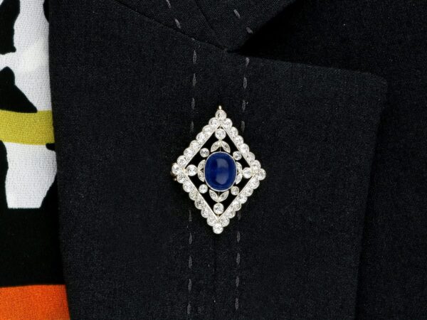 wearing an antique sapphire brooch