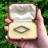 boxed Cartier Black Onyx and Diamond Brooch outside