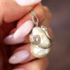 holding Pearl Diamond and Ruby Snake Pendant