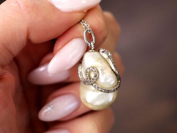 holding Pearl Diamond and Ruby Snake Pendant