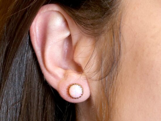 Opal Earrings On Ear Closeup
