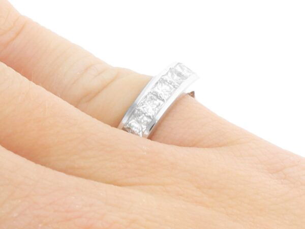 princess cut diamond eternity ring on finger