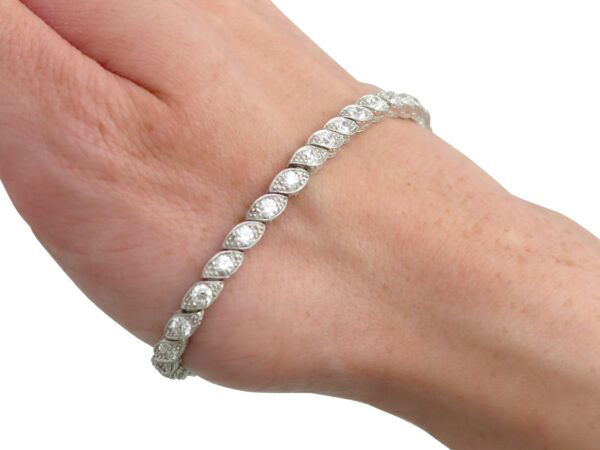 wearing antique diamond tennis bracelet in platinum