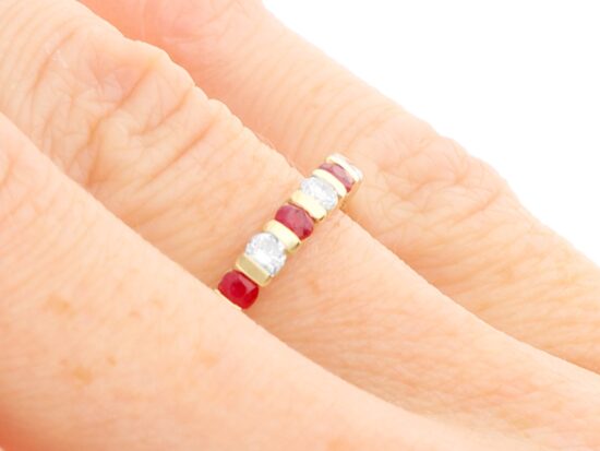 Ruby and Diamond Eternity Ring in Yellow Gold on hand