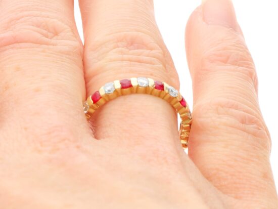 Ruby and Diamond Eternity Ring in Yellow Gold on finger