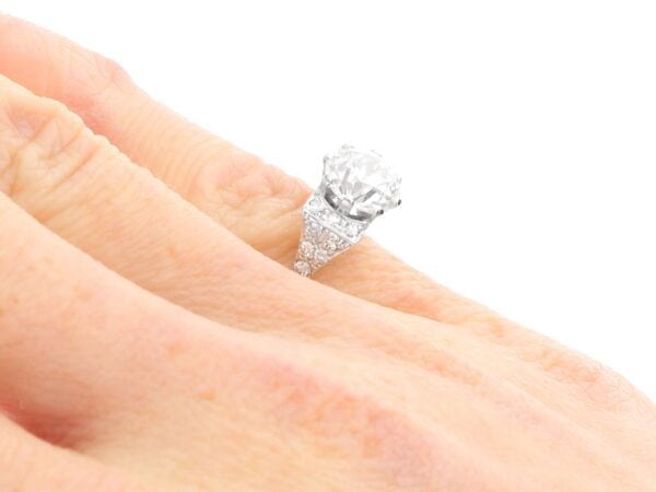 old European cut diamond solitaire ring on finger