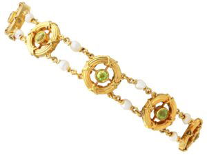 A stunning, fine and impressive antique peridot, natural pearl and 15 carat yellow gold bracelet; part of our diverse antique jewellery and estate jewelry collections. SKU: C8949