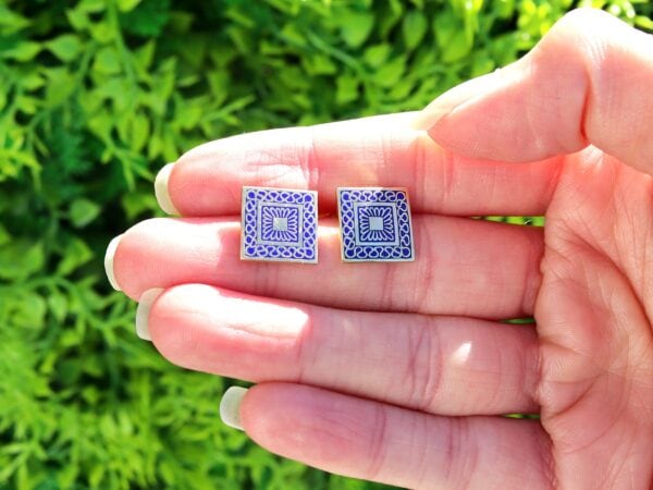 antique gold and enamel cufflinks in hand