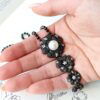 black diamond and pearl pendant in hand
