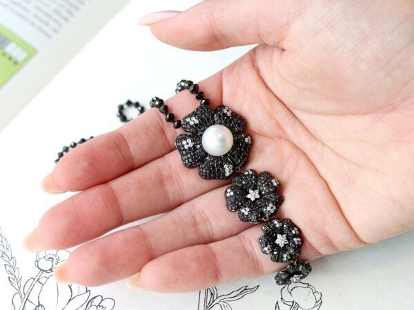 black diamond and pearl pendant in hand