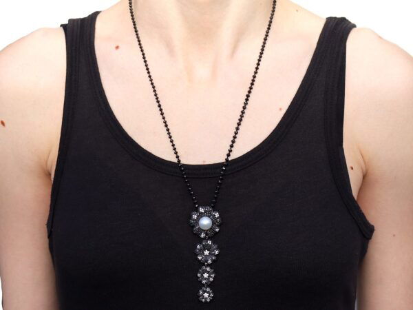 wearing black diamond and pearl pendant