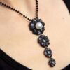 black diamond and pearl pendant on neck