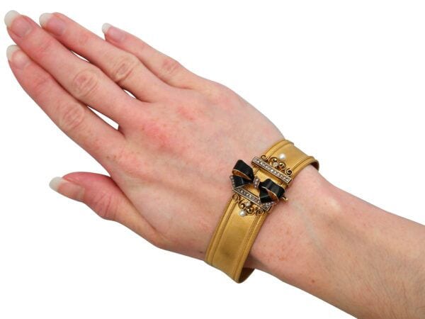 Gold and Black Enamel Bracelet On Hand
