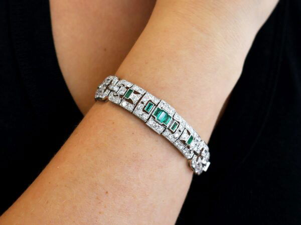 platinum Art Deco emerald and diamond bracelet on wrist