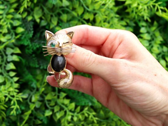 Vintage Gemstone and Gold Cat Brooch outside
