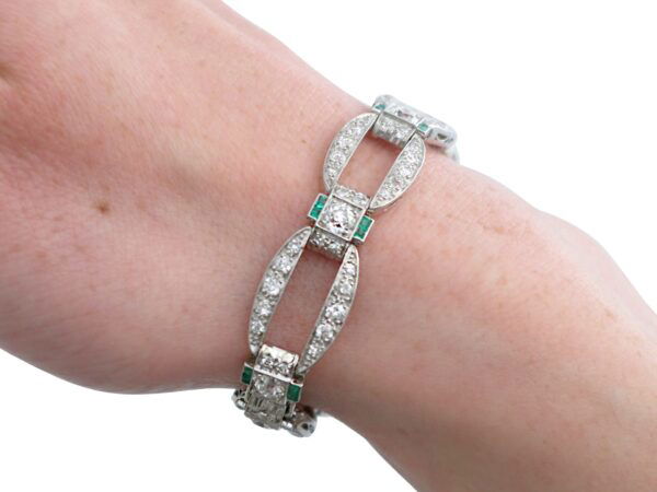 weraing art deco diamond and emerald bracelet
