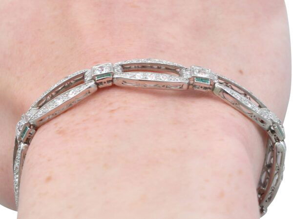 art deco diamond and emerald bracelet on wrist