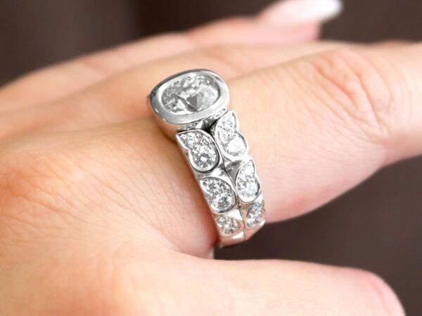 wearing a white gold 2 carat bezel set diamond ring