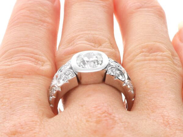 wearing 2 carat bezel set diamond ring