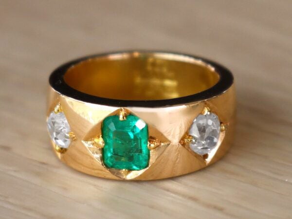 yellow gold band with emerald and diamonds